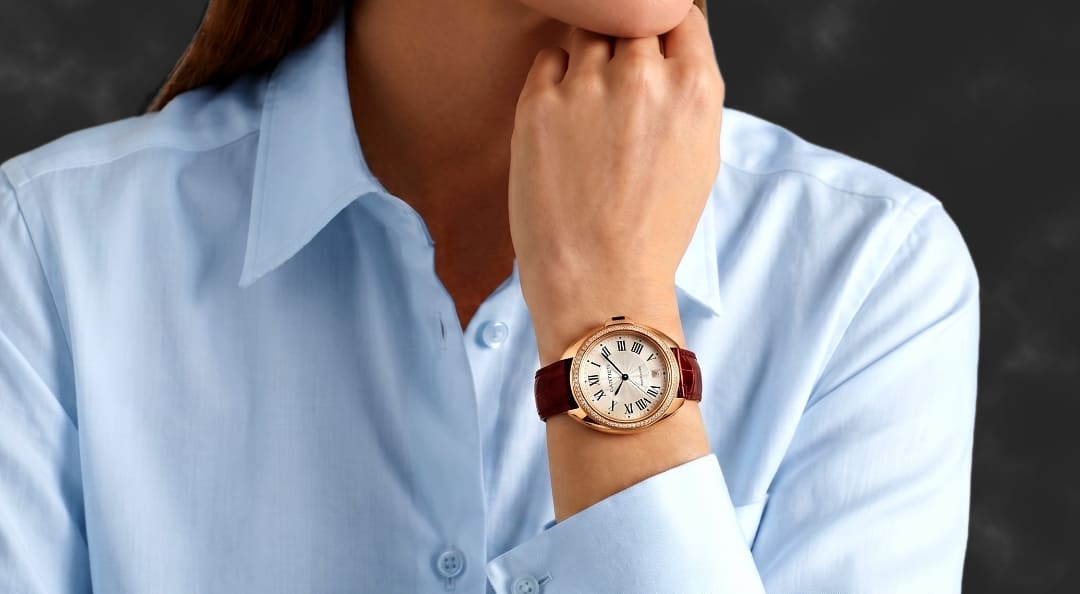 A photo of an arm wearing a Cartier Clé de Cartier watch.
