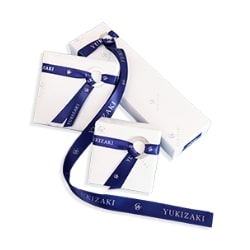 White box wrapped in navy blue ribbon