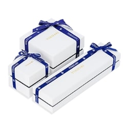 White box wrapped in navy blue ribbon